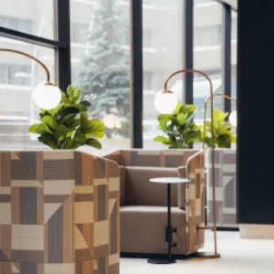 Bright hotel lobby with patterned lounge chairs, globe lamps, and greenery accents — modern hospitality design for boutique and luxury hotel marketing