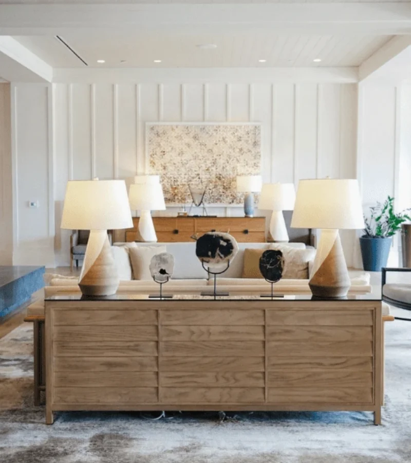 Bright hotel lobby with modern furnishings, warm lighting, and natural textures evoking a sense of hospitality and relaxed luxury